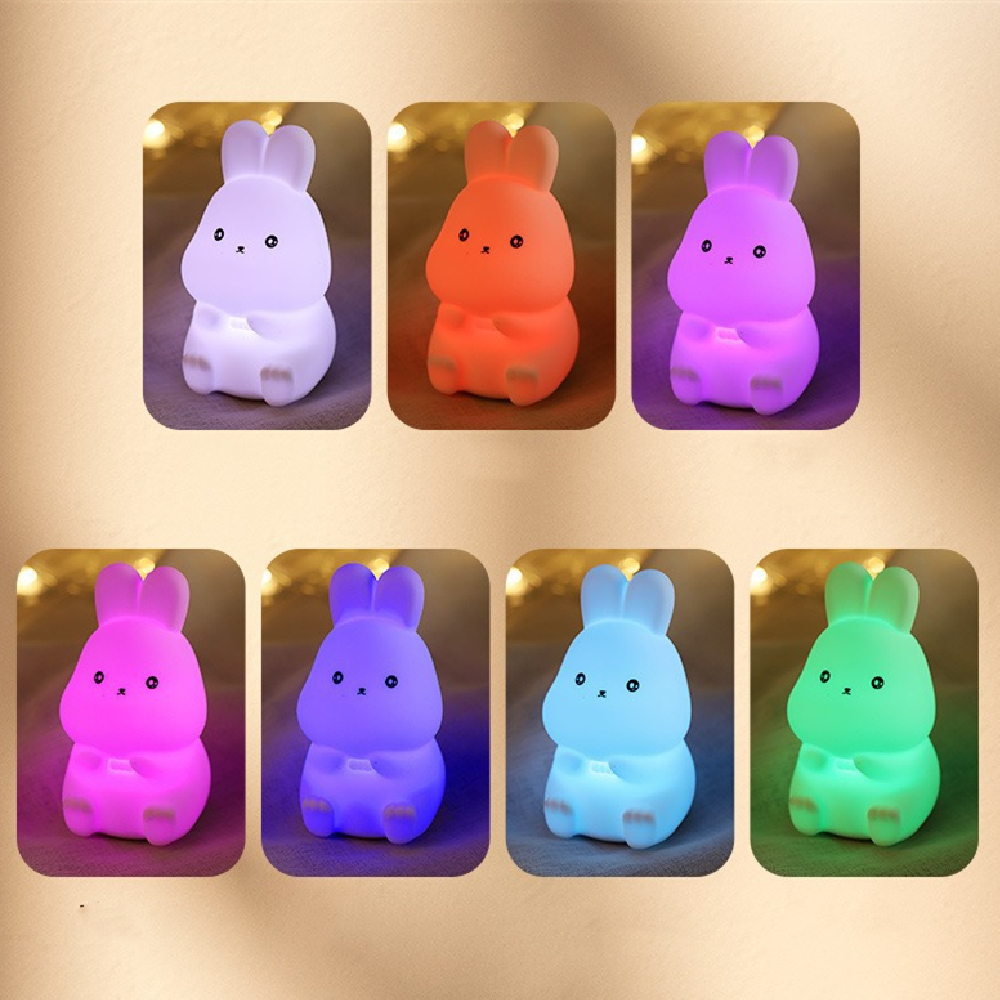 Set of colorful rabbit-shaped night lights on a gold background