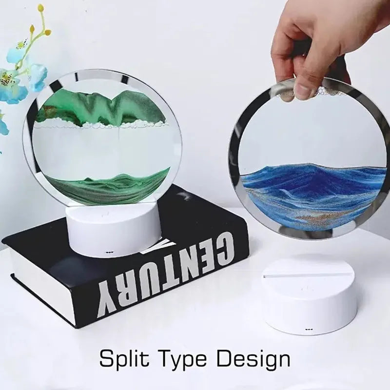 Two circular devices with landscape designs on stands, one green and one blue, with a hand holding the blue device.
