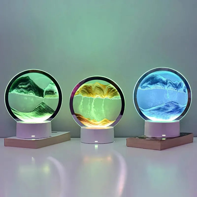 Three circular light fixtures with mountain landscape displays on a white surface.